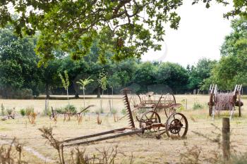 peasant household with abandoned farm equipment in village de Breca, Briere Regional Natural Park, France