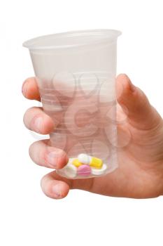 plastic cup with dose of pills in hand isolated on white background