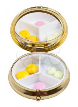 compact pill box with mirror and several tablets isolated on white background