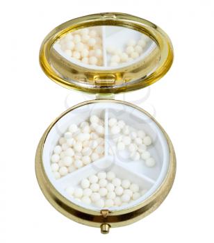 compact pill box with mirror and sugar homeopathy balls isolated on white background