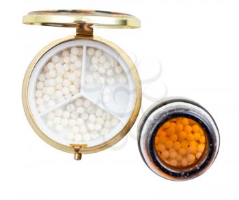 golden pill box and homeopathy sugar balls in glass brown jar isolated on white background