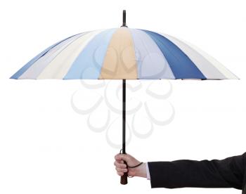male hand hold open striped umbrella isolated on white background