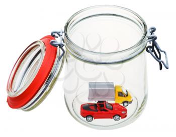 two new vehicles in open glass jar