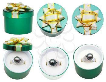 little round green box with black pearl ring isolated on white background