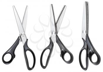 set of open modern pinking scissors with black handles isolated on white background