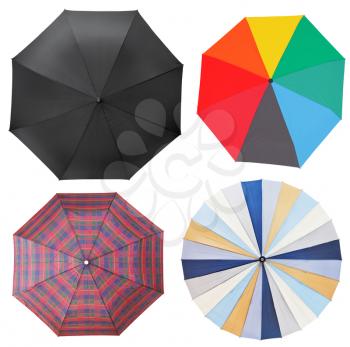top view of four different open umbrellas isolated on white background