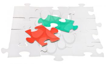 red and green pieces on assembled white puzzles isolated on white background