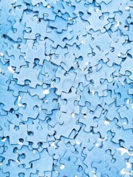 above view of many disassembled blue puzzle pieces