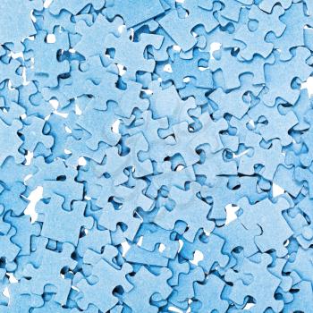 top view of many disassembled blue puzzle pieces