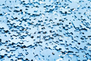 pile of disassembled blue puzzle pieces close up