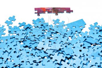 few connected pieces near of separated jigsaw puzzles isolated on white background