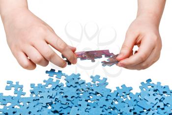 assembling of jigsaw puzzles isolated on white background