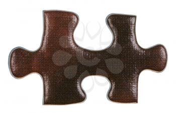 brown piece of jigsaw puzzle close up isolated on white background