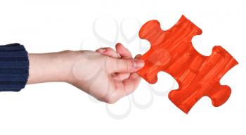 female hand with painted red puzzle piece isolated on white background