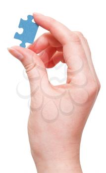 female arm holding jigsaw puzzle piece isolated on white background