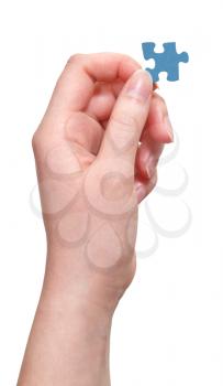 female hand holding puzzle piece isolated on white background