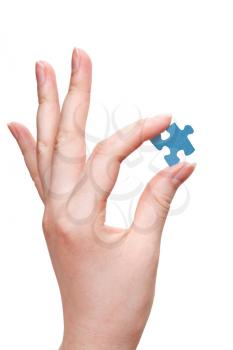 female arm holding puzzle piece isolated on white background