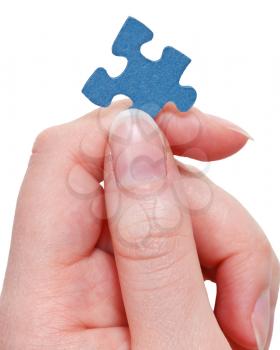 female fingers holding blue puzzle piece isolated on white background