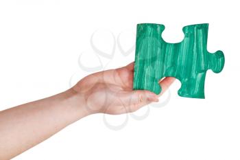 female hand with painted green puzzle piece isolated on white background