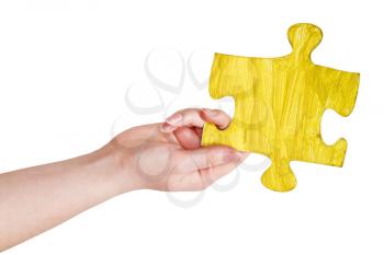 female hand with painted yellow puzzle piece isolated on white background