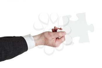 male hand holding big white paper puzzle piece isolated on white background