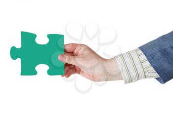 male hand with green puzzle piece isolated on white background