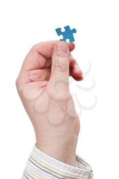 men hand in shirt holding jigsaw puzzle piece isolated on white background