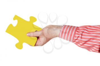 male hand with yellow puzzle piece isolated on white background