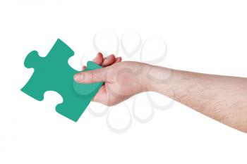 male hand with green puzzle piece isolated on white background