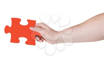 male hand with red puzzle piece isolated on white background