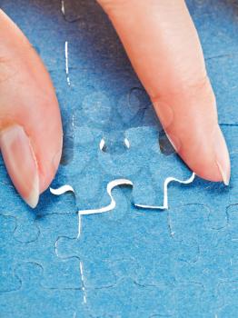 attaching the last piece of puzzle in free space in assembled jigsaw puzzles