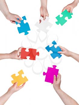 circle of people hands with different puzzle pieces isolated on white background