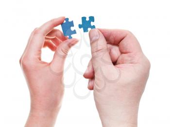 couple of male and female hands with little puzzle pieces isolated on white background