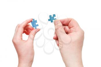 couple male and female hands with blue puzzle pieces isolated on white background