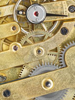 background from brass mechanical clockwork of vintage watch close up
