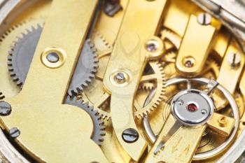 round brass clockwork of vintage pocket watch close up