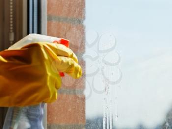 cleaning window glass - detergent jet from spray bottle