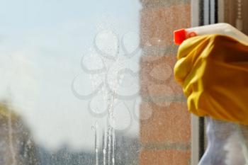 washing window glass - detergent jet from spray bottle