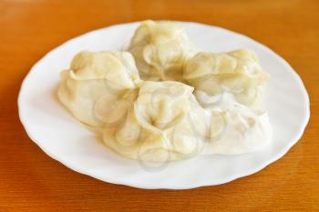 Crimean tatar cuisine - manti dumpling on white plate