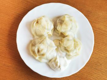 Crimean tatar cuisine - top view of manti dumpling on white plate