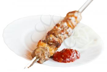 skewer with lamb shish kebab on white plate isolated on white background