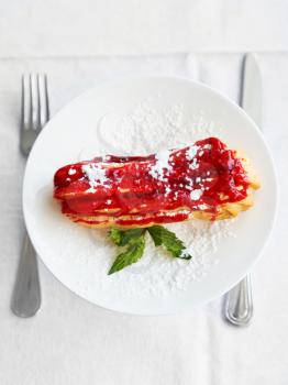 top view of dessert eclair on white plate