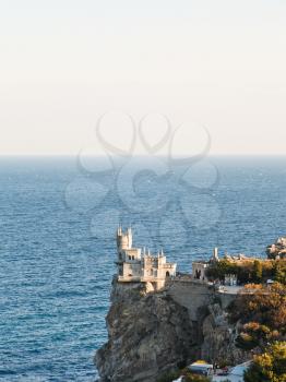Aurora cliff with Swallow's Nest castle on Southern Coast of Crimea in evening