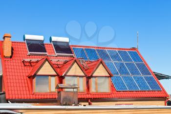 contemporary energy-saving technology - Solar Batteries and heaters on home roof