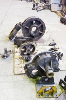 Details of disassembled engine on floor in mechanical workshop
