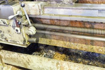 metal turning in sump of lathe machine in turnery