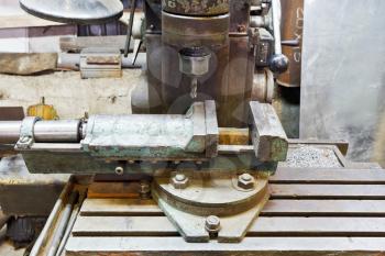 vice and drill of old boring machine close up in locksmith workshop