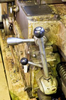 handles of tailstock of metal lathe machine close up in turning workshop