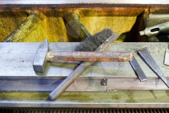 hammer and metal brush on boring machine frame