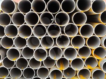 rows of steel pipes close up on outdoor warehouse in winted